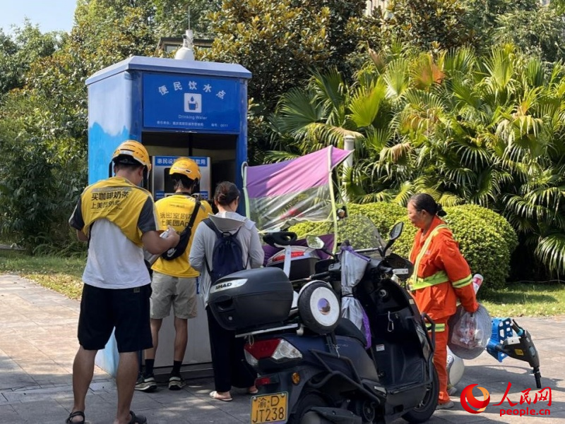 9月5日，正在“0011”號(hào)便民飲水點(diǎn)排隊(duì)接水的市民。周小平攝